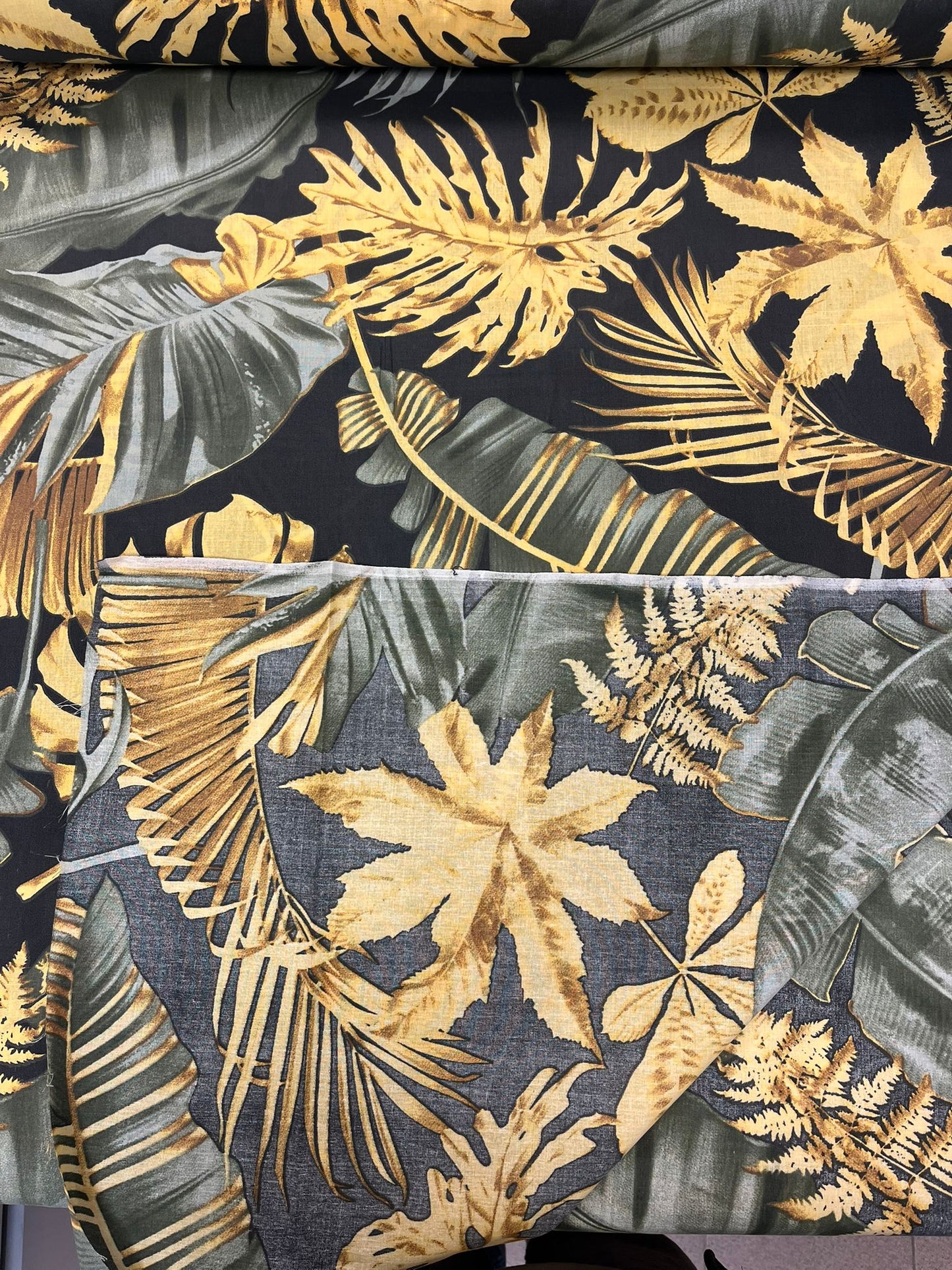 Image de tissu 100 % coton à feuilles sombres 125 g/m² – disponible chez Šarlotes audumi
