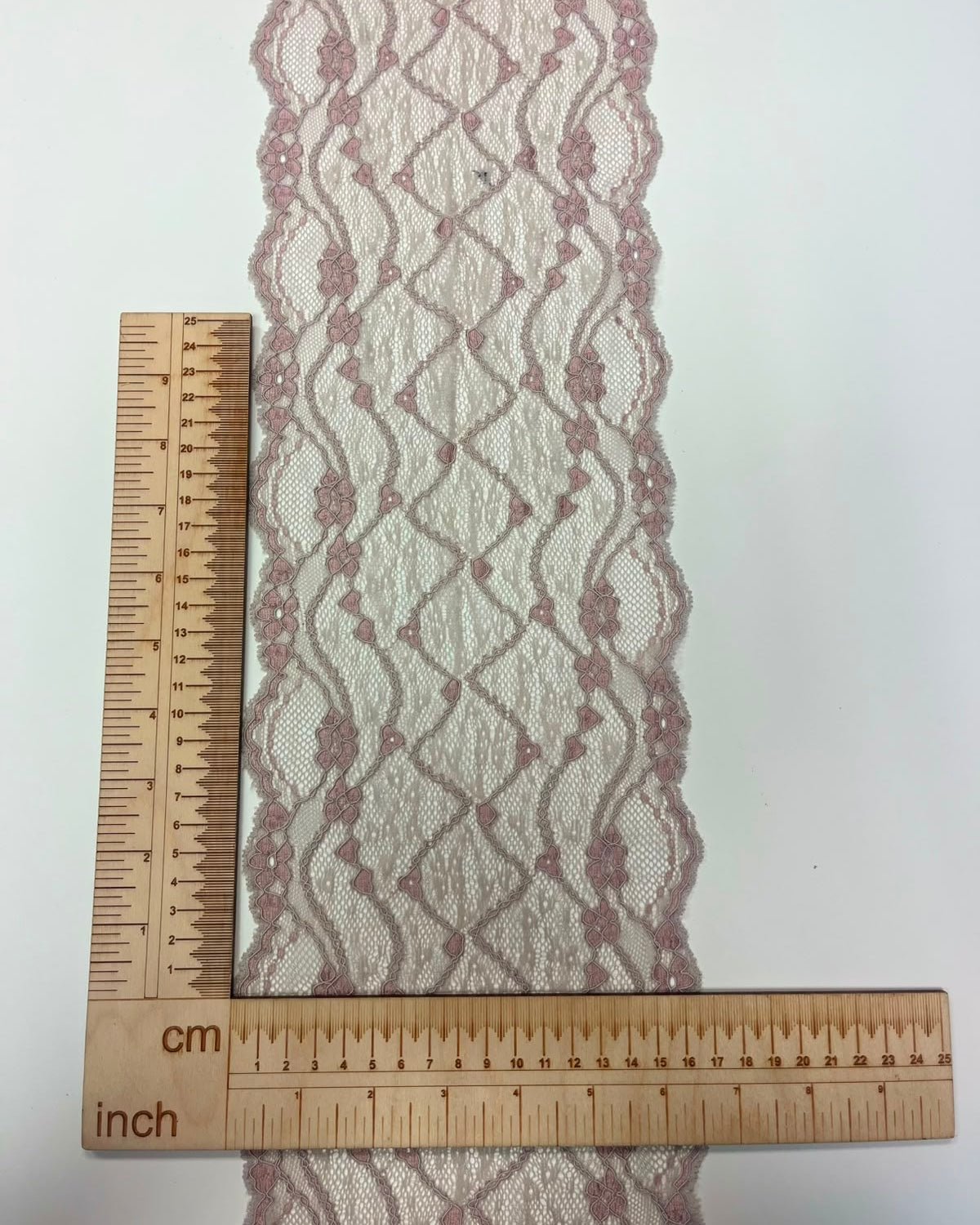 Image of embroidered lace on tulle, 16 cm, gray with powder pink accents – available online at Charlotte's Fabrics