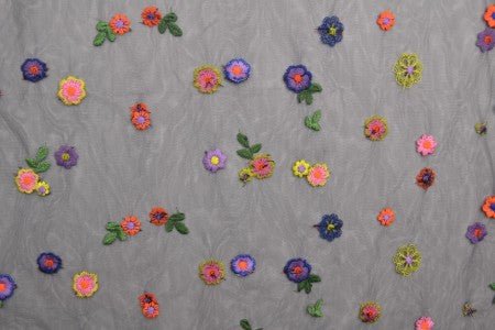 Image of embroidered tulle fabric with flowers - black shade 70 g/m² – available at Šarlotes audumi