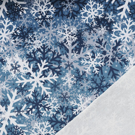 Attēls ar Kokvilnas cilpiņtrikotāža - pārsliņas uz zila fona 250 g/m² – pieejams Šarlotes audumi