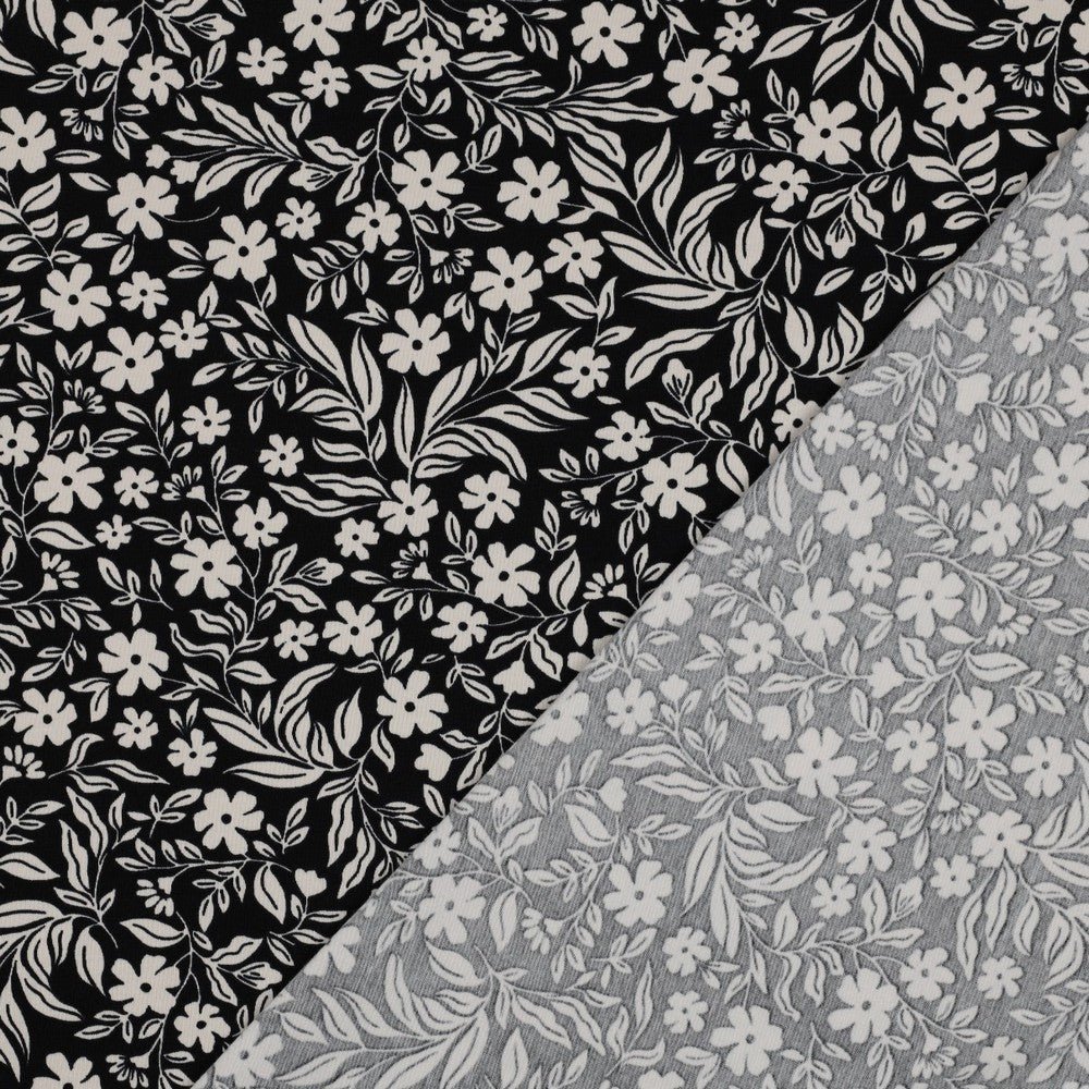 Attēls ar Kokvilnas trikotāža - balti ziedi uz melna 200 g/m² – pieejams Šarlotes audumi