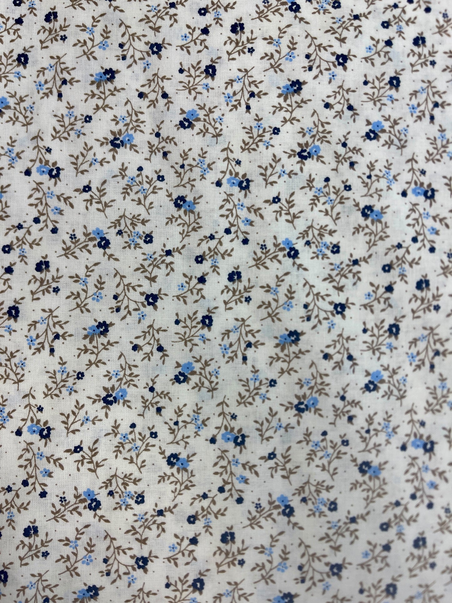 Image of 100% cotton fabric with tiny, delicate flowers – available online at Charlotte's Fabrics