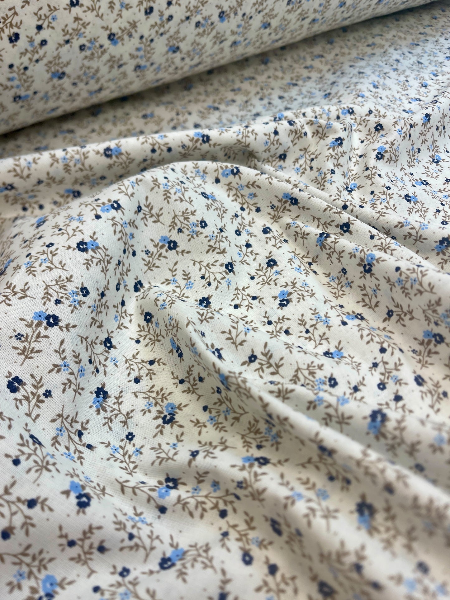 Image of 100% cotton fabric with tiny, delicate flowers – available online at Charlotte's Fabrics