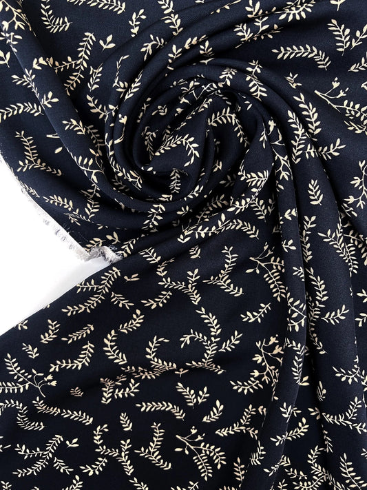 Attēls ar 100% Viskozes audums - bēšas lapiņas uz tumši zila 96 g/m² – pieejams Šarlotes audumi