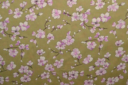 Image with 100% viscose fabric - cherry blossoms on a pistachio green background, 100 g/m² – available at Charlotte's Fabrics