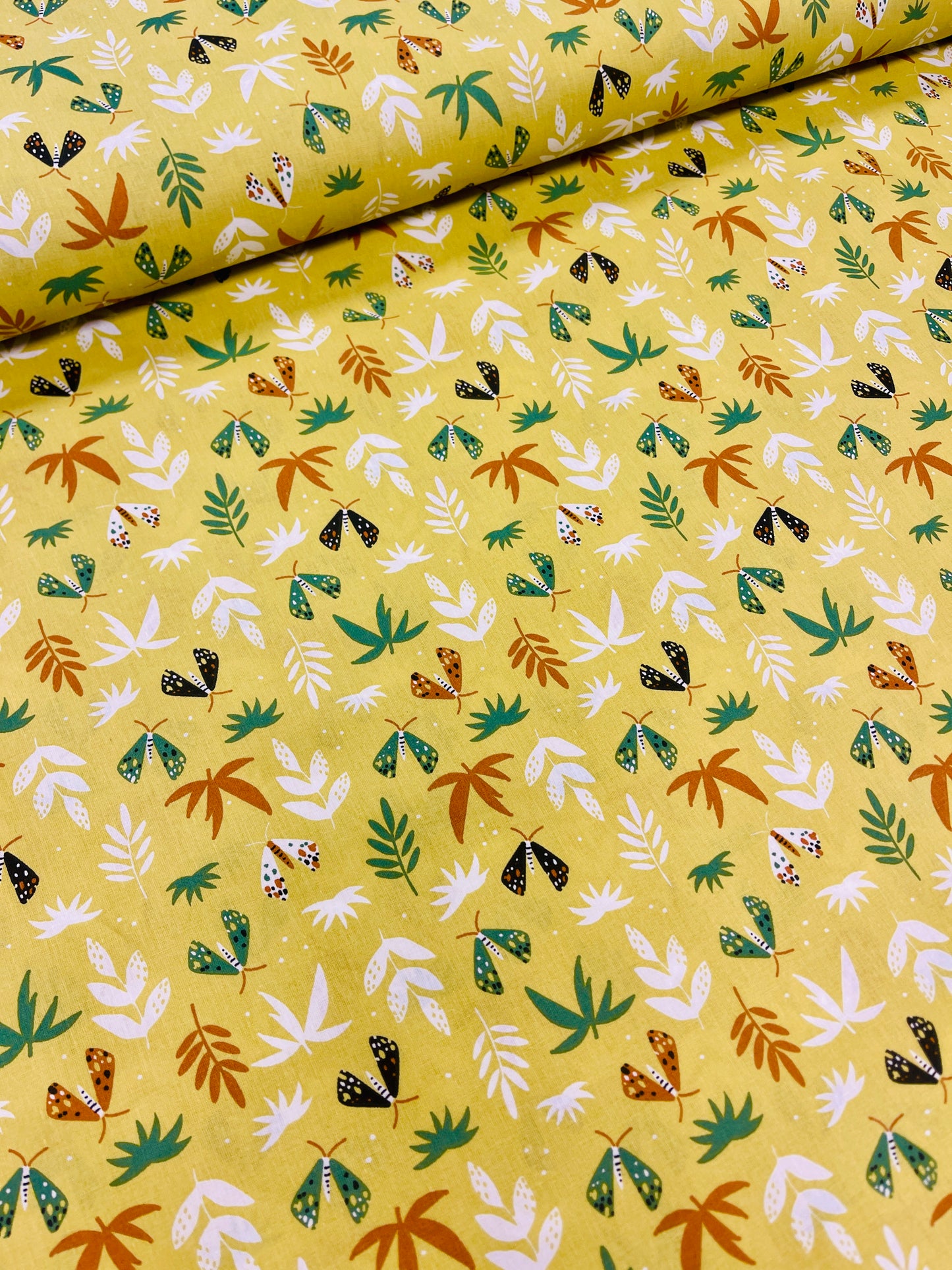 100% Kokvilnas audums-lapiņas uz dzeltenzaļa fona 125 g/m²