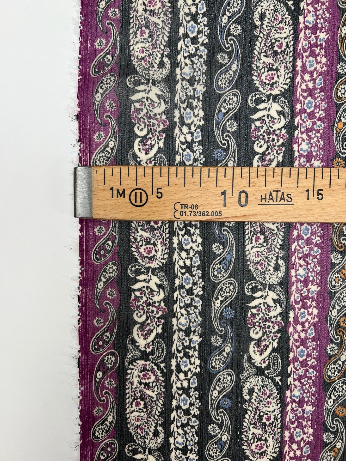 Image of Italian chiffon fabric with a black and purple paisley pattern and lurex thread – available online at Charlotte's Fabrics