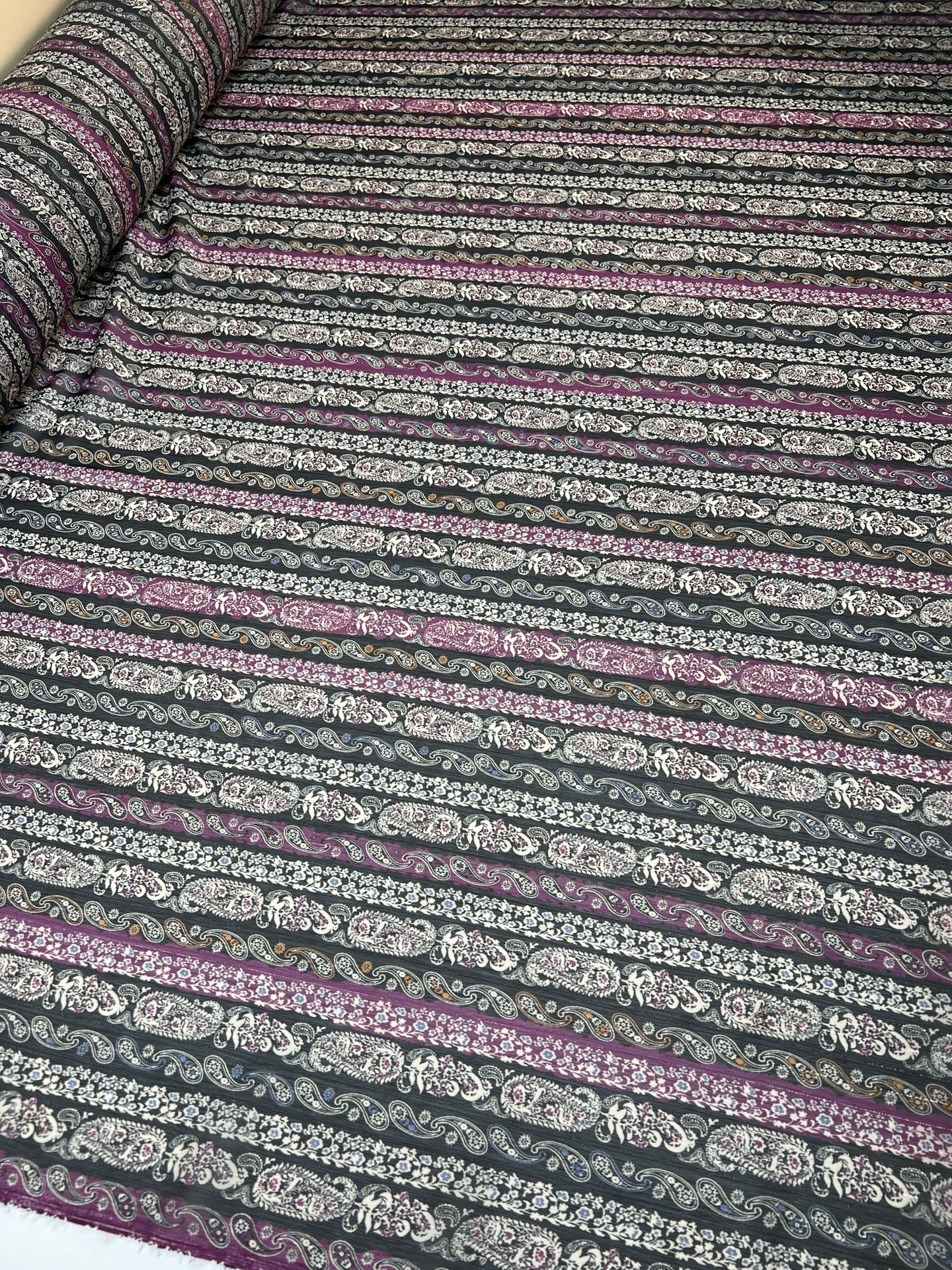 Image of Italian chiffon fabric with a black and purple paisley pattern and lurex thread – available online at Charlotte's Fabrics