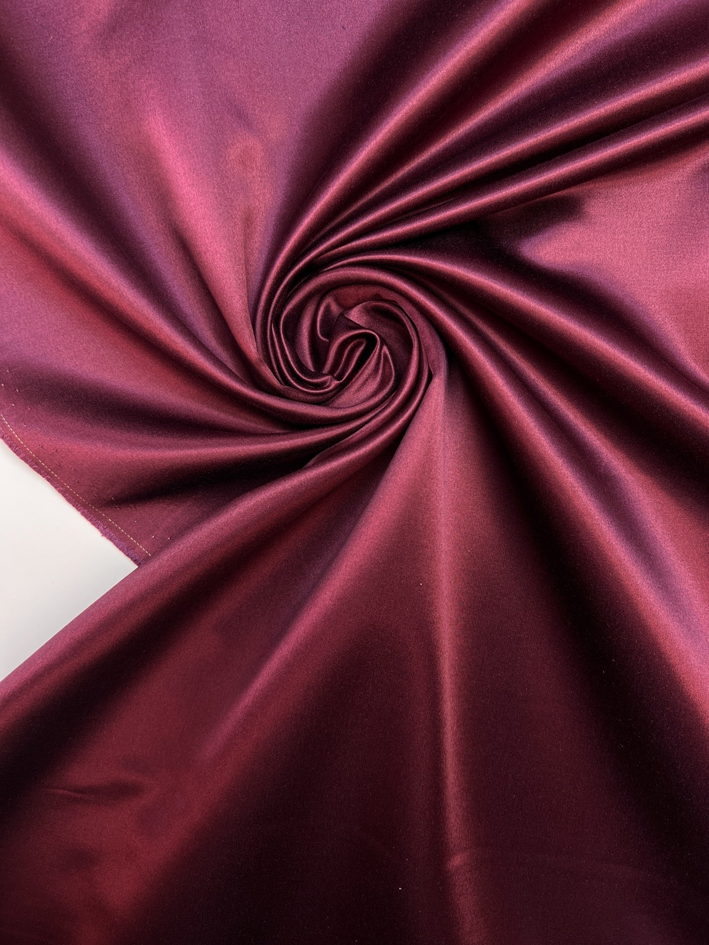 Image of Italian silk and cotton satin fabric in a dark purple shade – available online at Charlotte's Fabrics