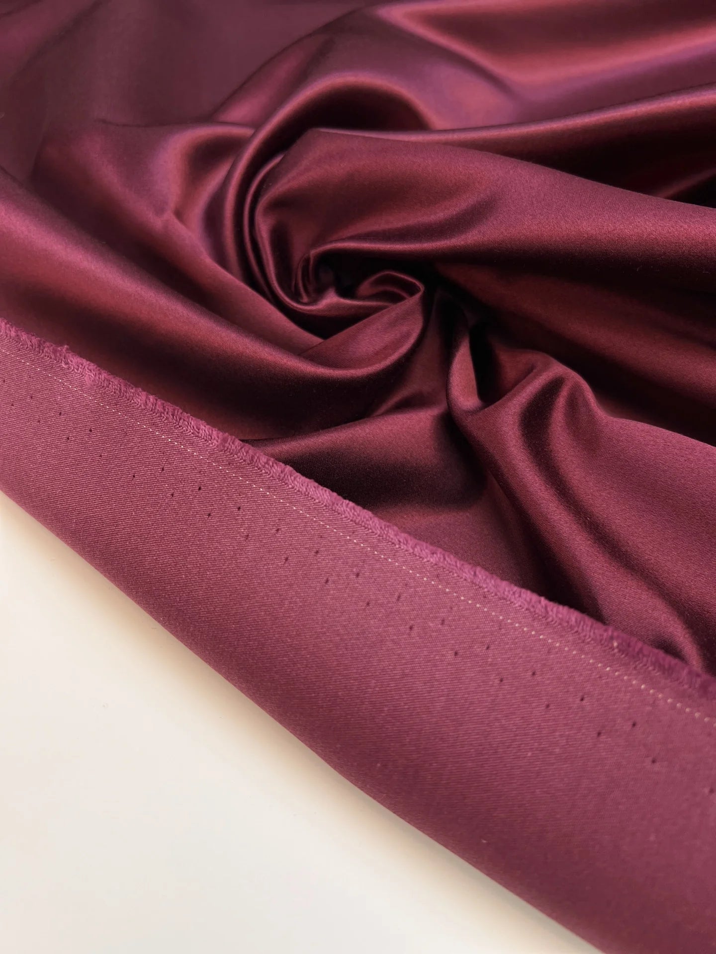 Image of Italian silk and cotton satin fabric in a dark purple shade – available online at Charlotte's Fabrics
