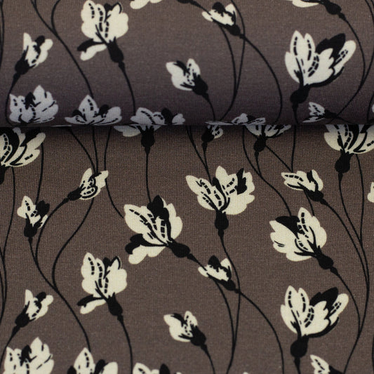 Image with cotton jersey fabric, floral pattern on a grey-brown background, 210 g/m² – available online at Charlotte's Fabrics