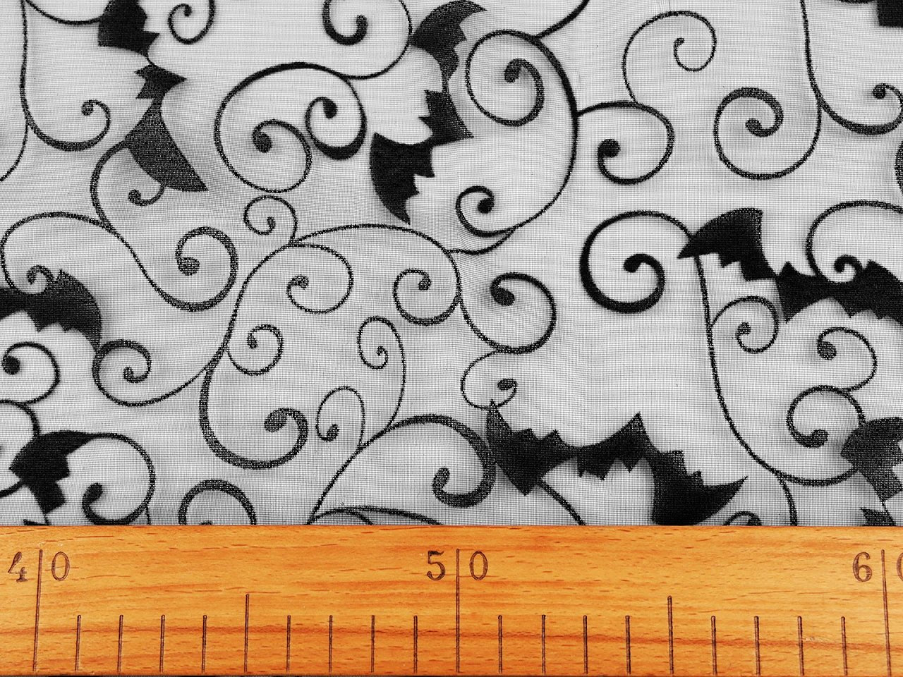 Image of black organza with bat Halloween decorations – available online at Charlotte's Fabrics