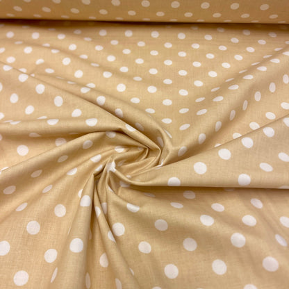 Tissu 100 % coton à pois sur fond jaune pâle 125 g/m²